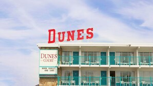 A hotel named 'DUNES COURT' with a sign indicating 'BOOK DIRECT AND SAVE'. - Dunes Court (Ocean City)