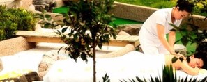 A spa setting with a person receiving a massage.