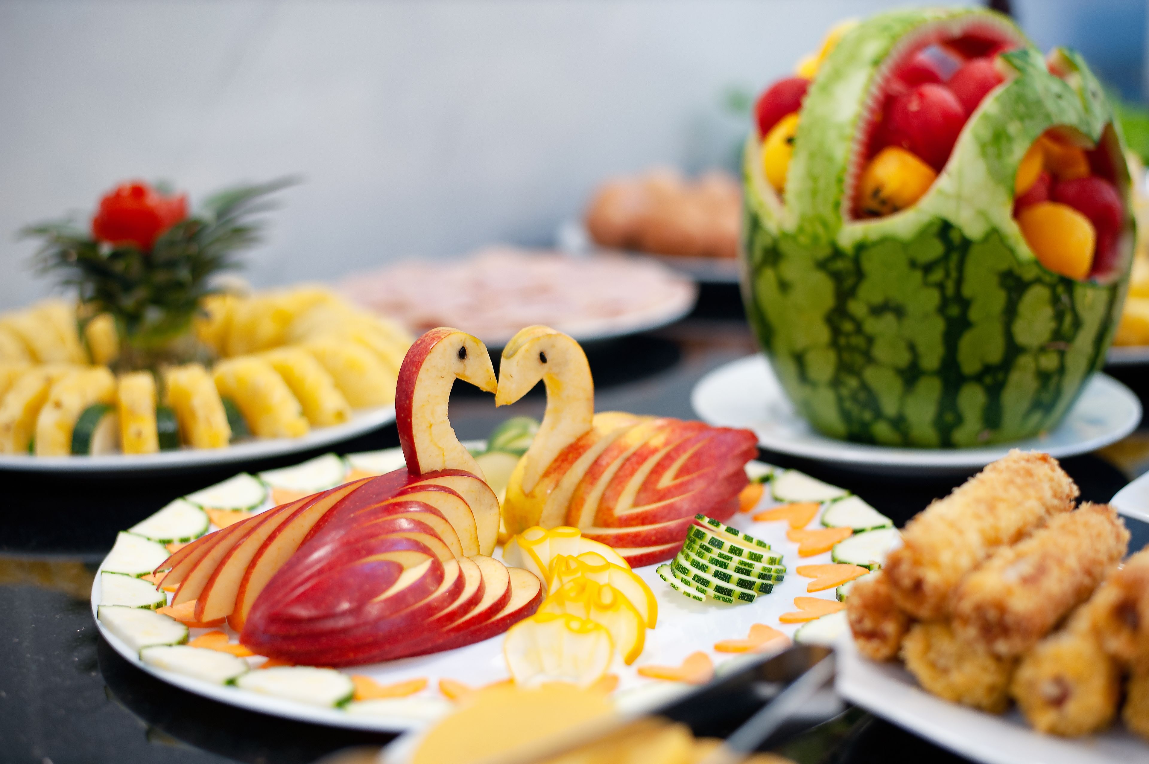 A variety of fruit and vegetable dishes on a table.