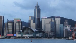 A city skyline with prominent buildings including a tall skyscraper and several commercial structures. - Australian Guest House (Kowloon)