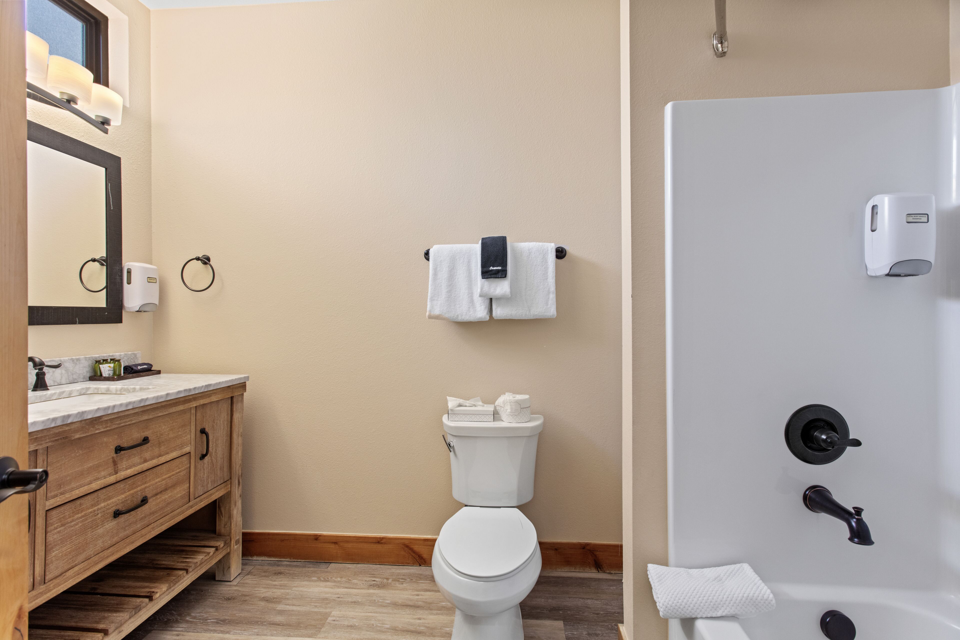 A bathroom with a toilet, sink, and shower.
