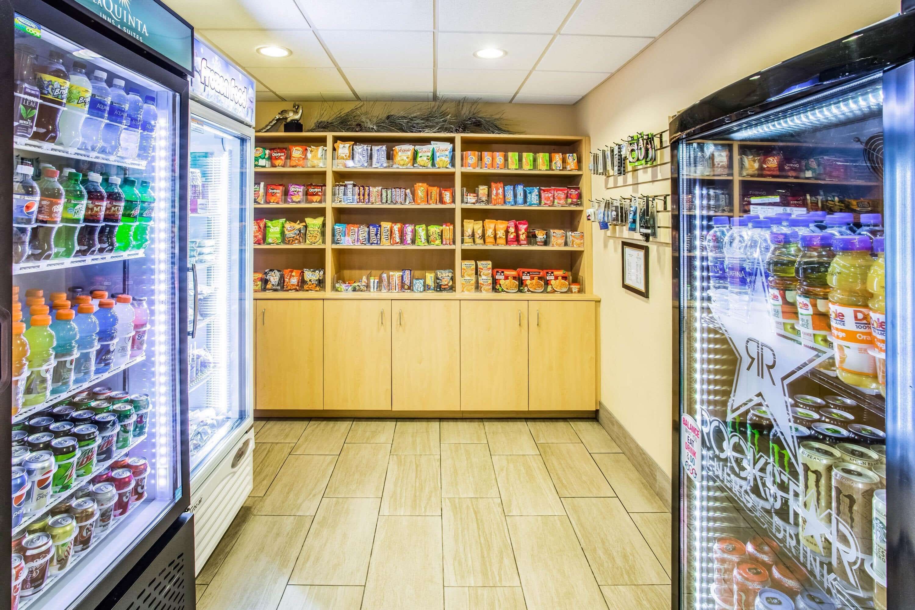 A vending area with multiple beverage dispensers and snack shelves.