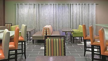 A restaurant with a variety of seating options including booths and individual tables.