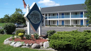 Fontana Village Inn features a two-story building with a garden and blue balconies.