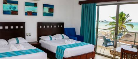 A hotel room with two beds, a balcony with a view of the sea, and artwork on the wall.