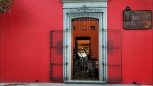 A red building with a metal gate and a sign that reads "Restaurante Andino". - Hotel Boutique Parador San Miguel (Oaxaca)