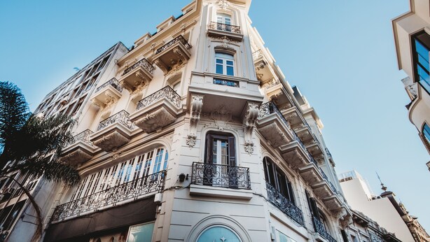 A multi-story building with ornate balconies and a classical architectural style. - Viajero Montevideo Hostel (Montevideo)