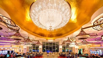 Experience the grandeur of our lobby, featuring a stunning chandelier, gaming tables, and ornate ceiling designs.