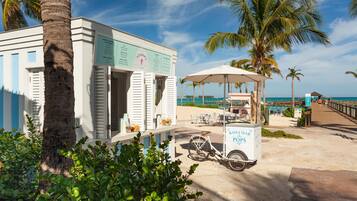 On the beach, white sand, beach cabanas, sun-loungers