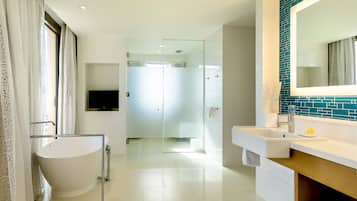 A modern bathroom with a freestanding bathtub, a vanity with a mirror, and a shower area.