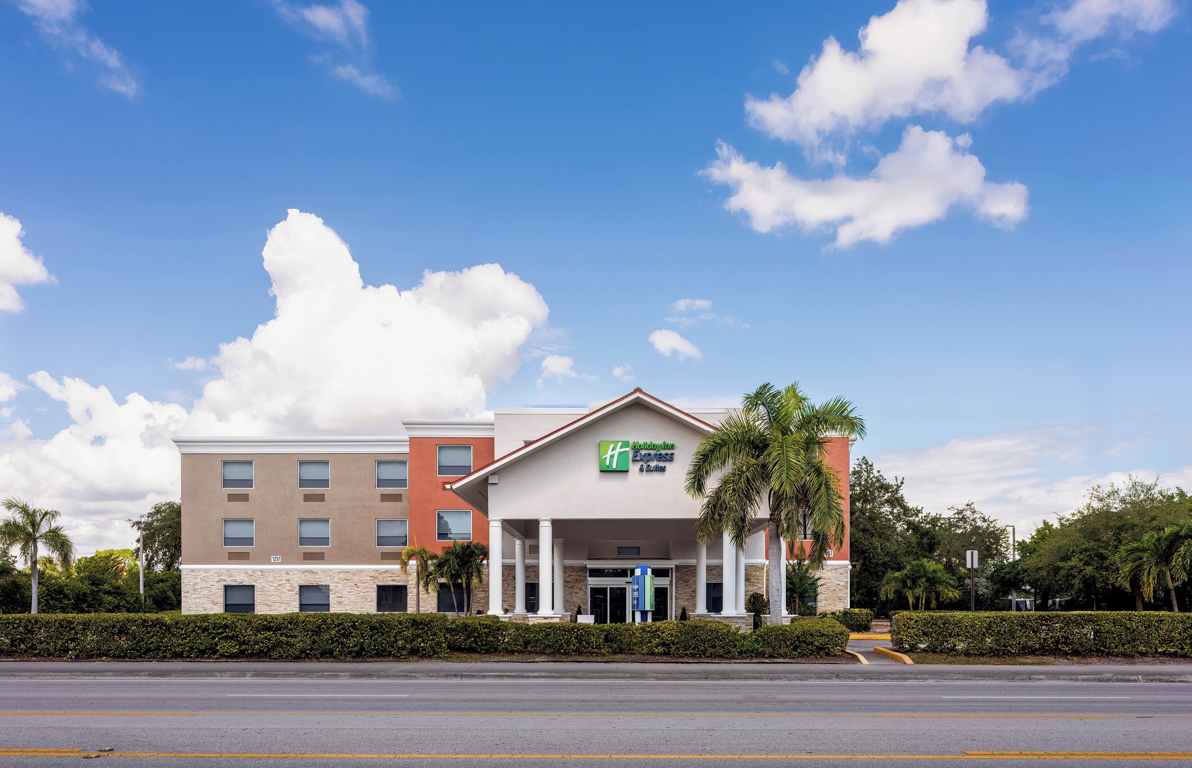 A Holiday Inn Express building with a flat roof, multiple windows, and a signboard.