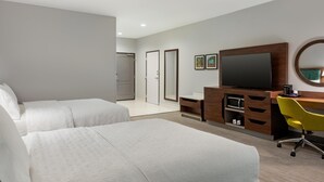 A hotel room with two beds, a TV, a desk with a chair, and a bathroom visible in the background. - Hampton Inn Lake Charles (Lake Charles)