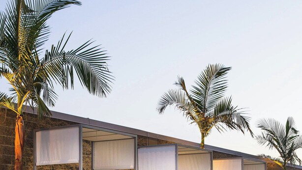A poolside area with a row of sunbeds, each with a canopy. - Residence Inn Los Angeles L.A. LIVE (Los Angeles)