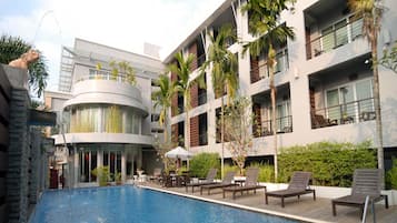 Relax by the pool surrounded by lounge chairs and umbrellas, with stunning views from the balconies and terraces.