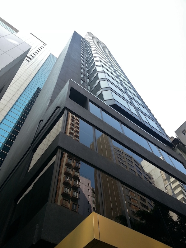 A high-rise building with a modern glass facade and a geometric design.