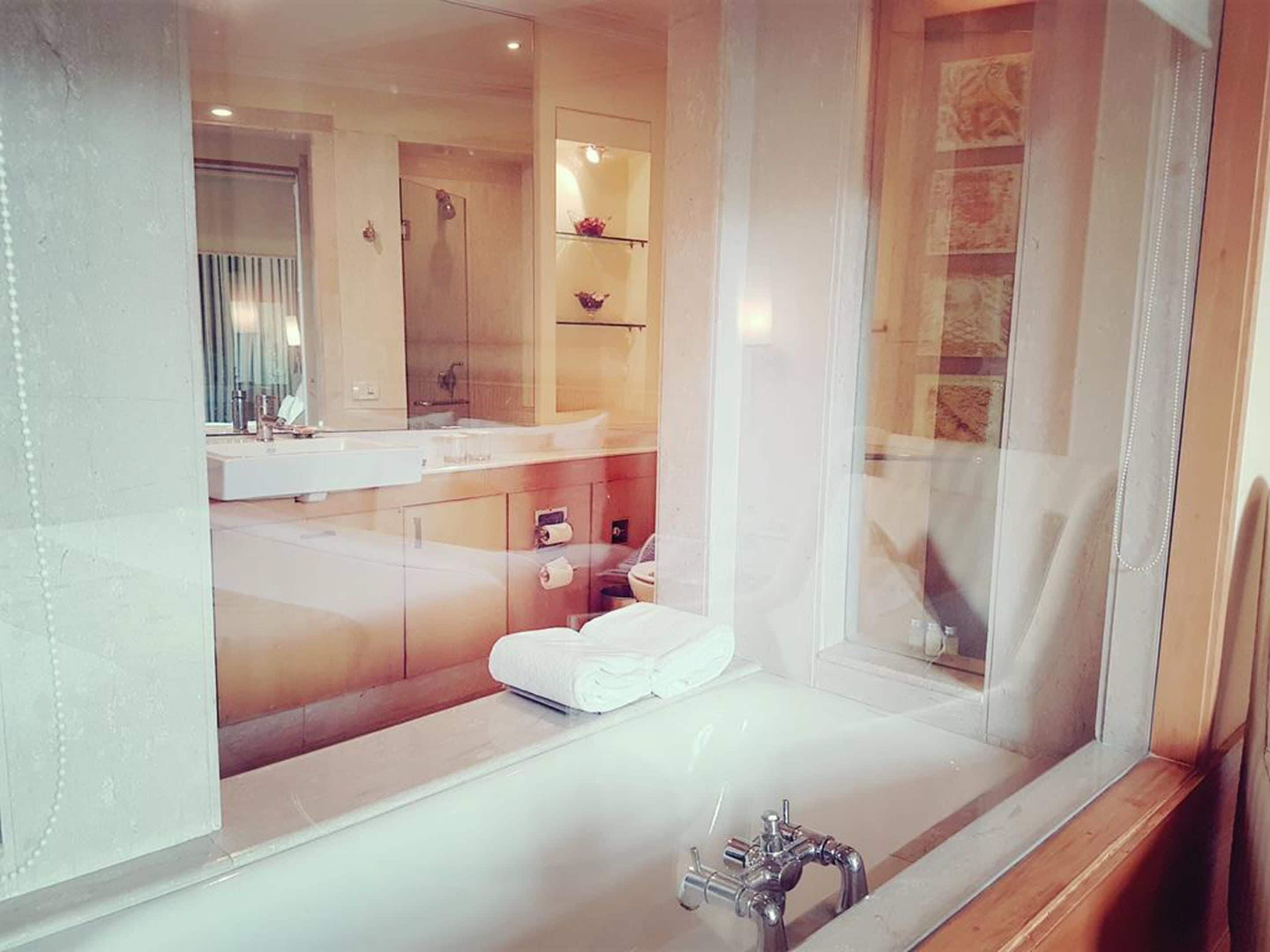 combined shower/bathtub, hair dryer, slippers, towels