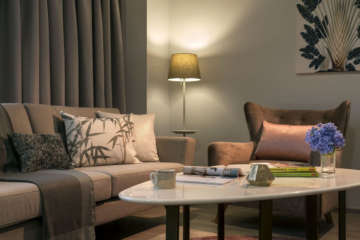 A modern living room with a sofa, armchair, and a coffee table.