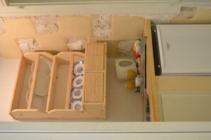 A compact kitchen with a wooden countertop, a sink, and a refrigerator. - Anatolia Charming Hotel (Chania)