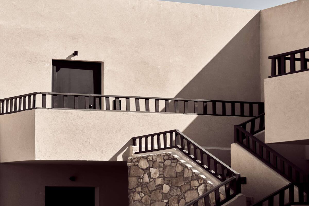 A building with a stone staircase and a door.