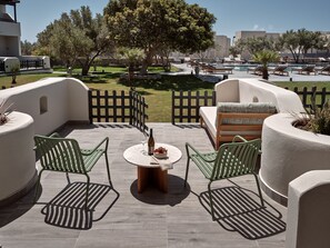 Relax in style on this serene patio, complete with a round table, comfortable seating, and a view of the pool.