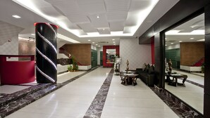 A spacious lobby with a marble floor, a red seating area, and a reception desk. - Innotel Luxury Business Hotel (Dhaka)