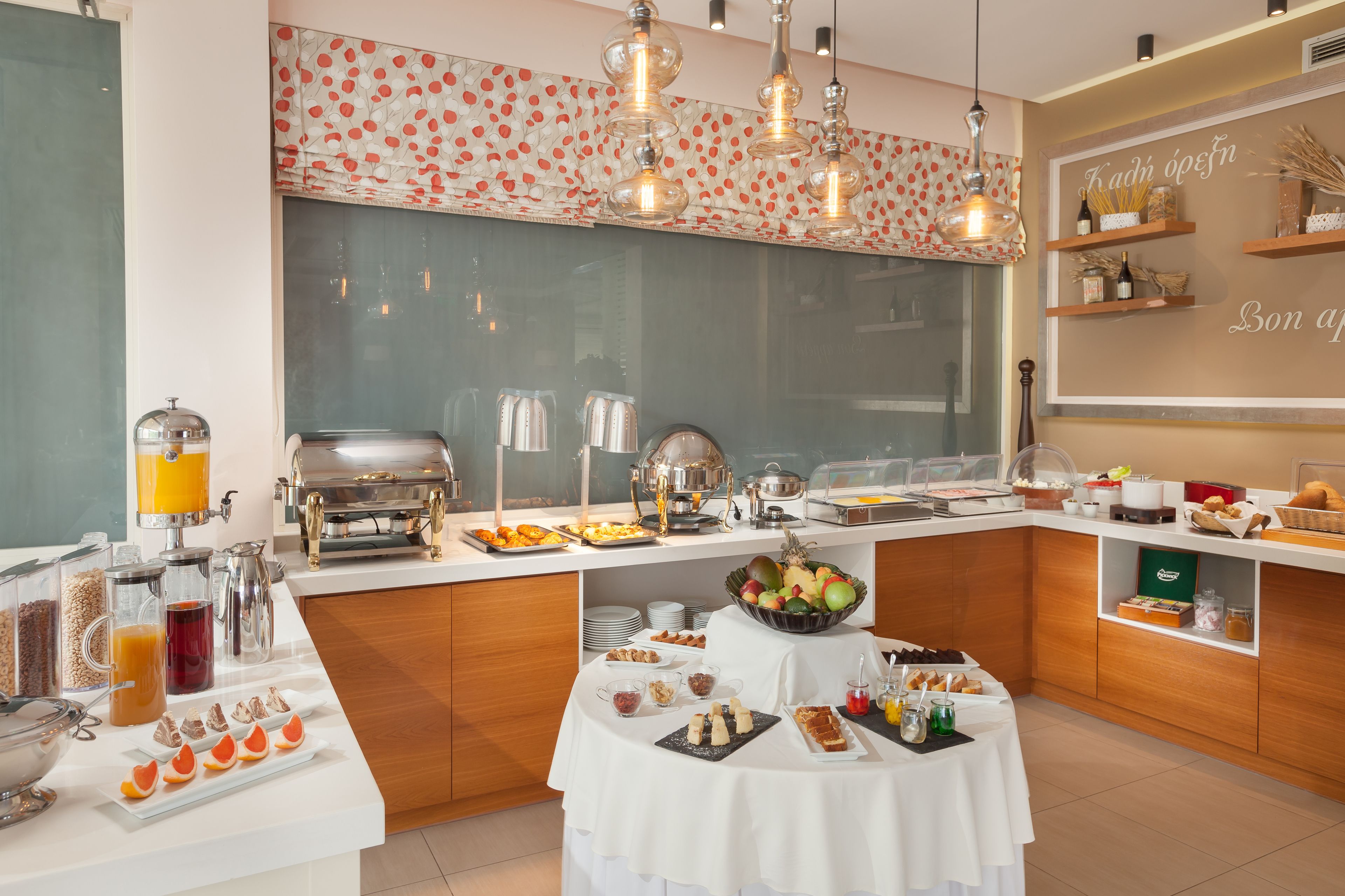 A breakfast buffet with various food items and beverages.