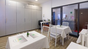 A conference room with white tables and chairs, a whiteboard, and a glass partition. - B&B A Picture of Rome (Rome)