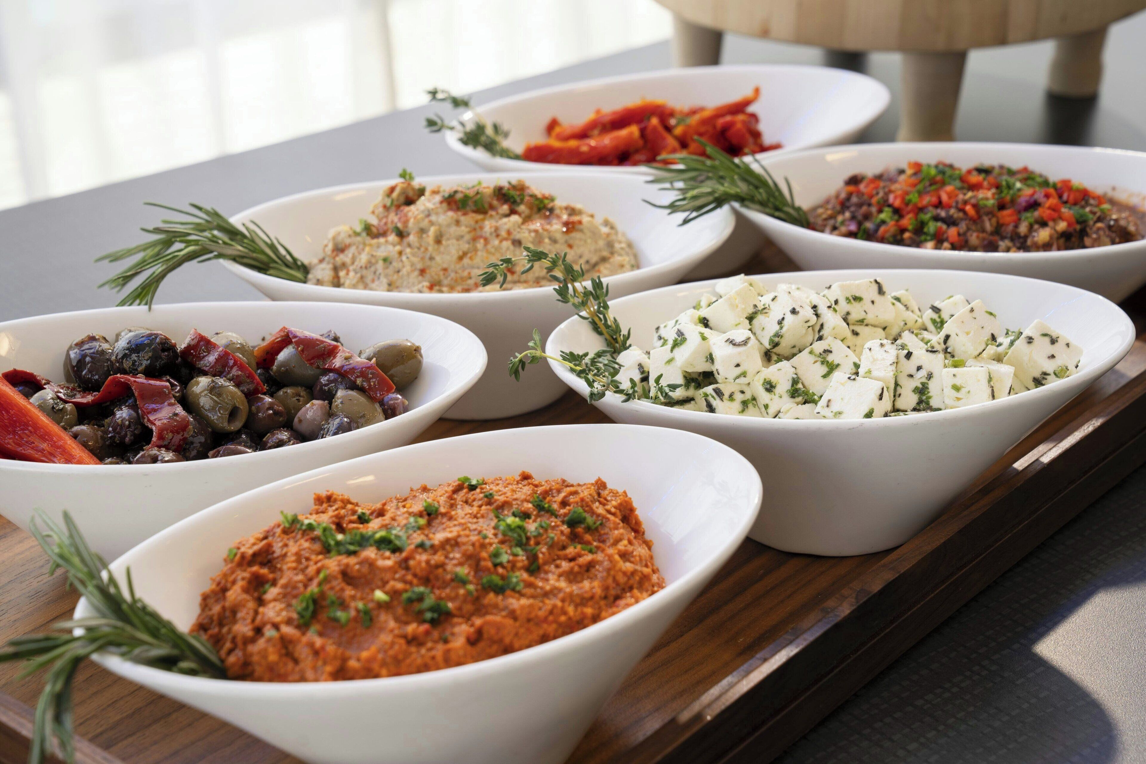 A variety of dishes arranged on a wooden table.