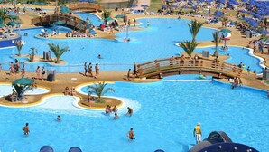 A large outdoor swimming pool with multiple lanes and a wooden bridge. - Corte Cristina (Quartucciu)