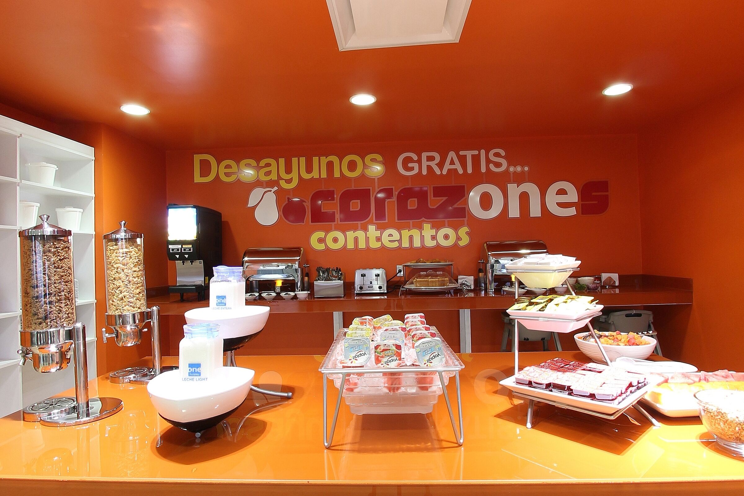 A buffet area with various food items and a coffee station.