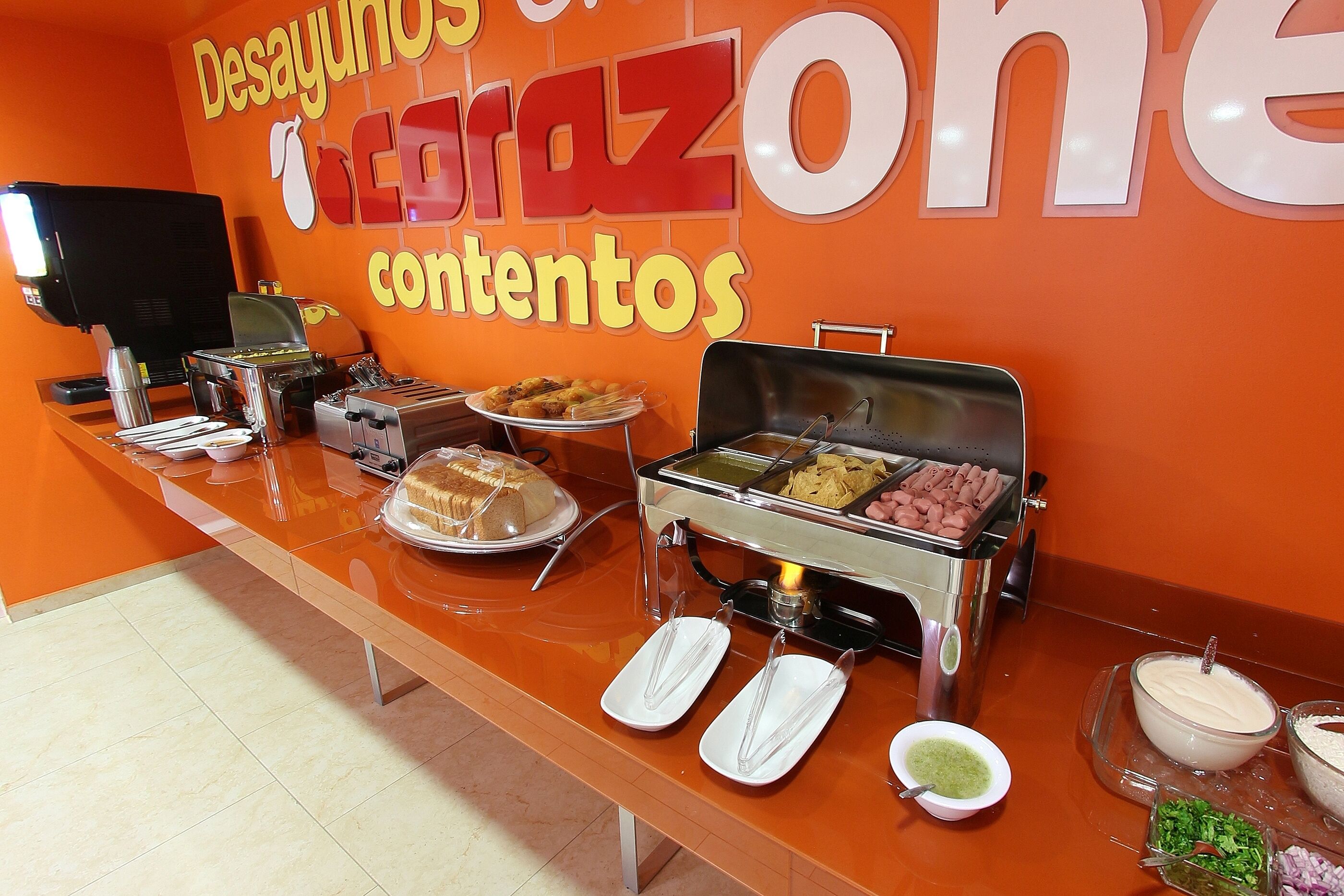 A buffet setup with various food items and condiments.