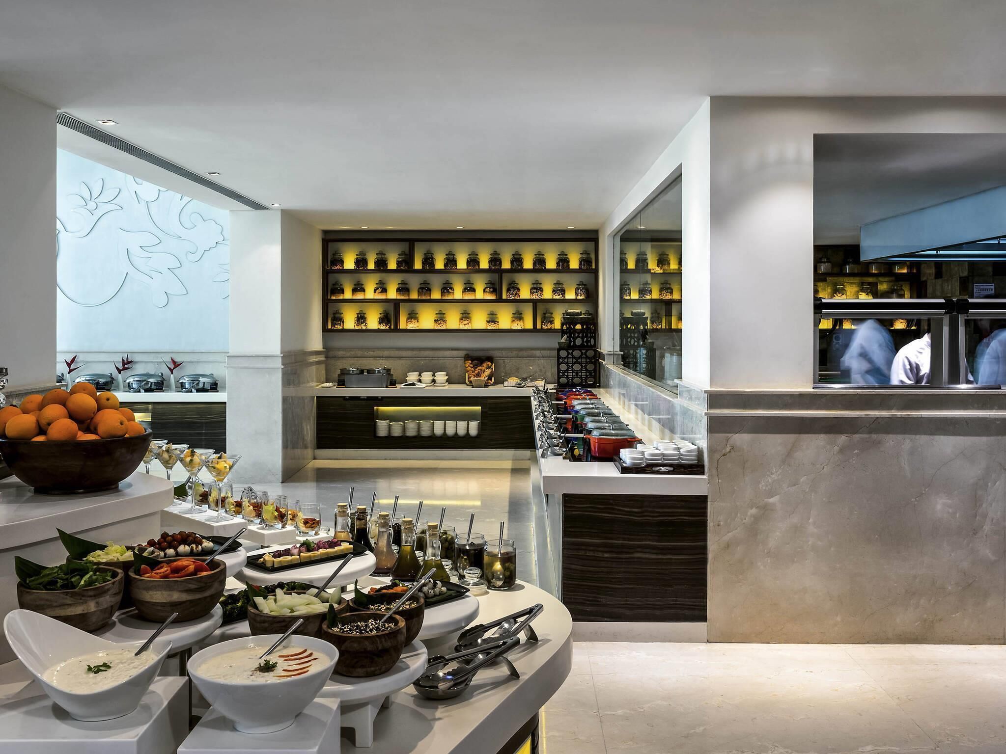 A buffet setup with various food items and condiments.