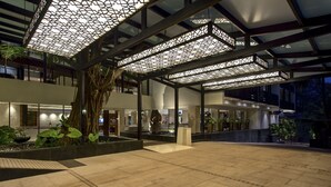 A modern hotel lobby with a geometric ceiling design, indoor plants, and a spacious seating area. - Novotel Goa Resort & Spa Candolim (Candolim)
