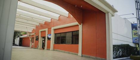 A building with a red exterior and a covered entrance area.
