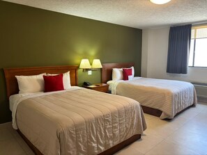 A hotel room with two beds, a green wall, and a window with curtains. - Baja Inn Hoteles La Mesa (Tijuana)