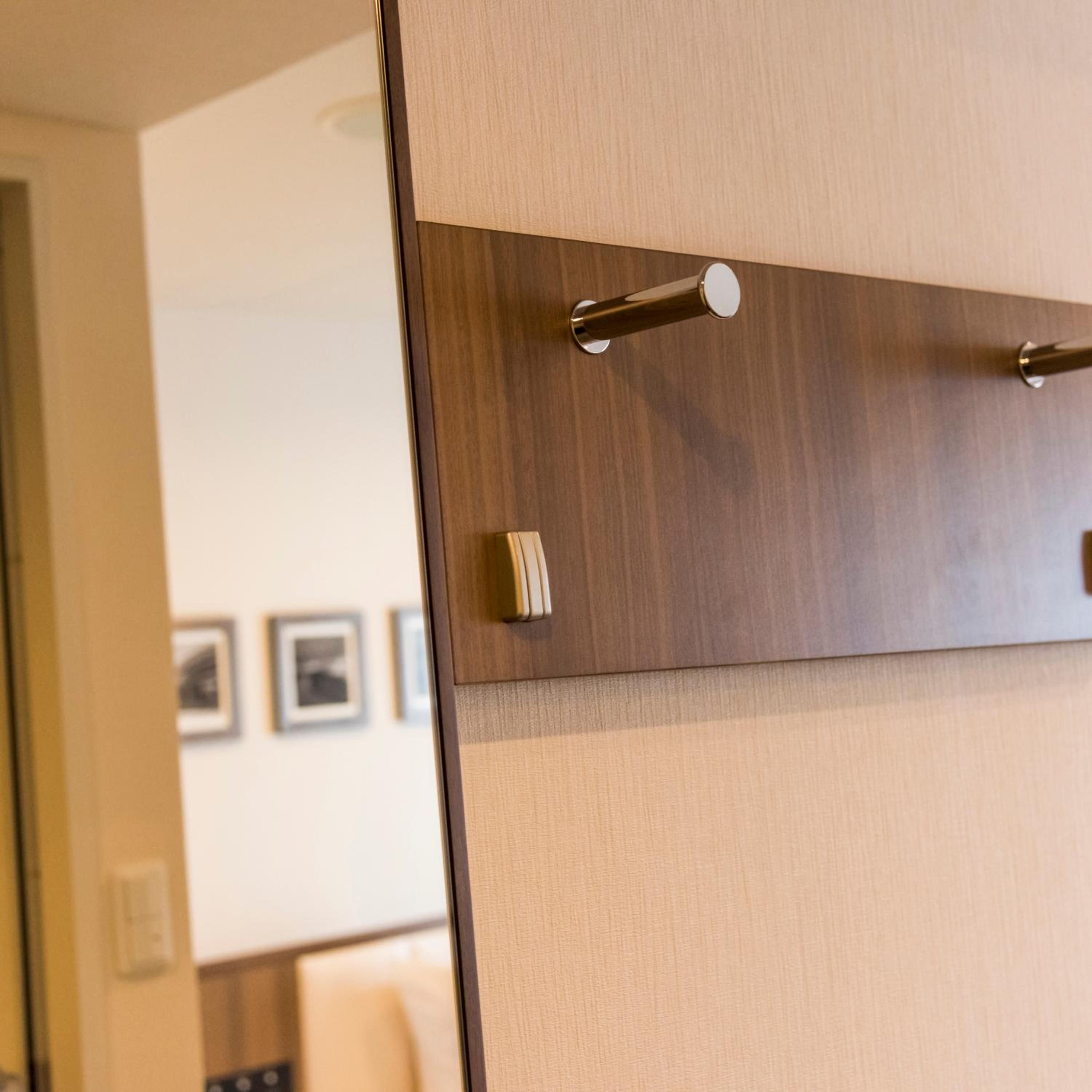 A wooden door with a metallic handle and a textured panel.