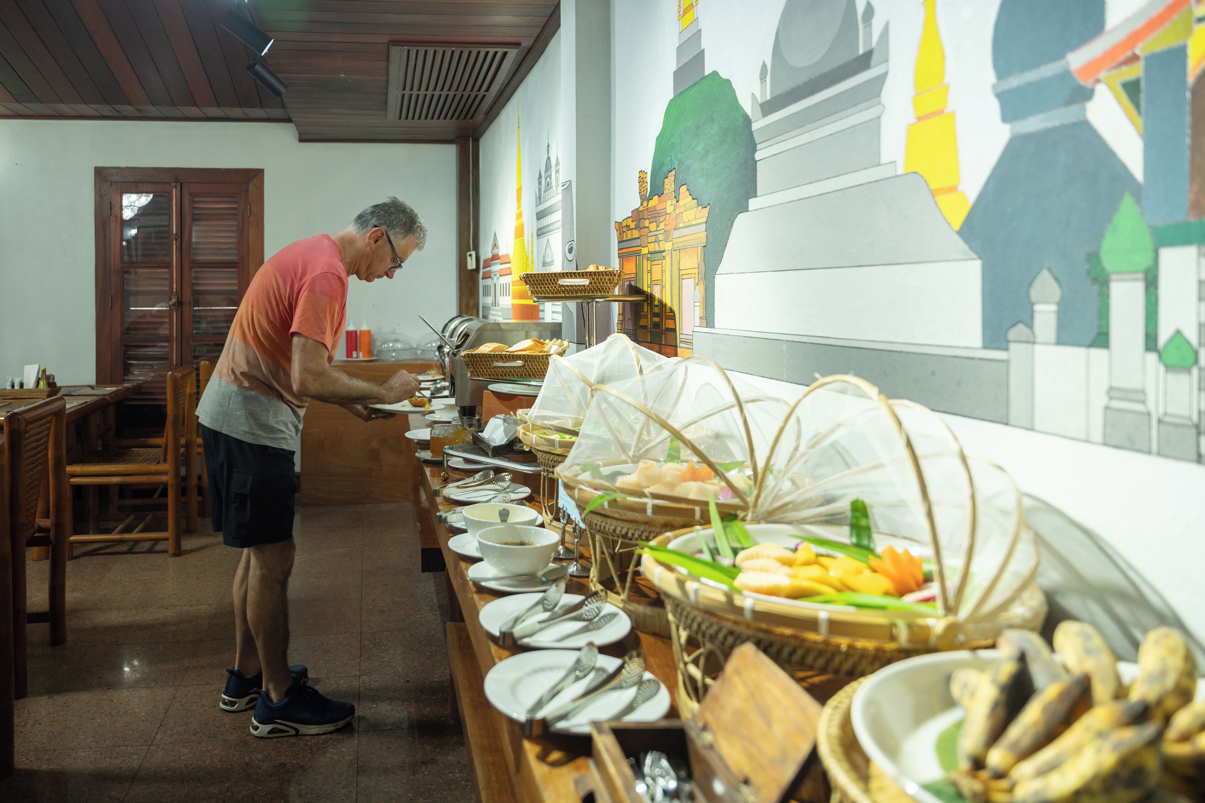 A buffet setup with various food items and utensils.