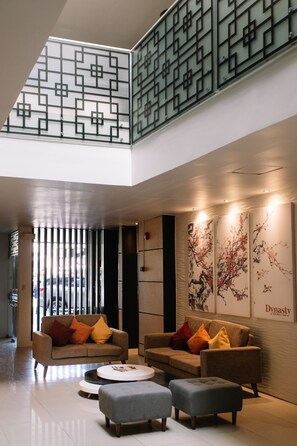 Relax in the stylish lobby with sofas, a coffee table, and artwork on the walls.