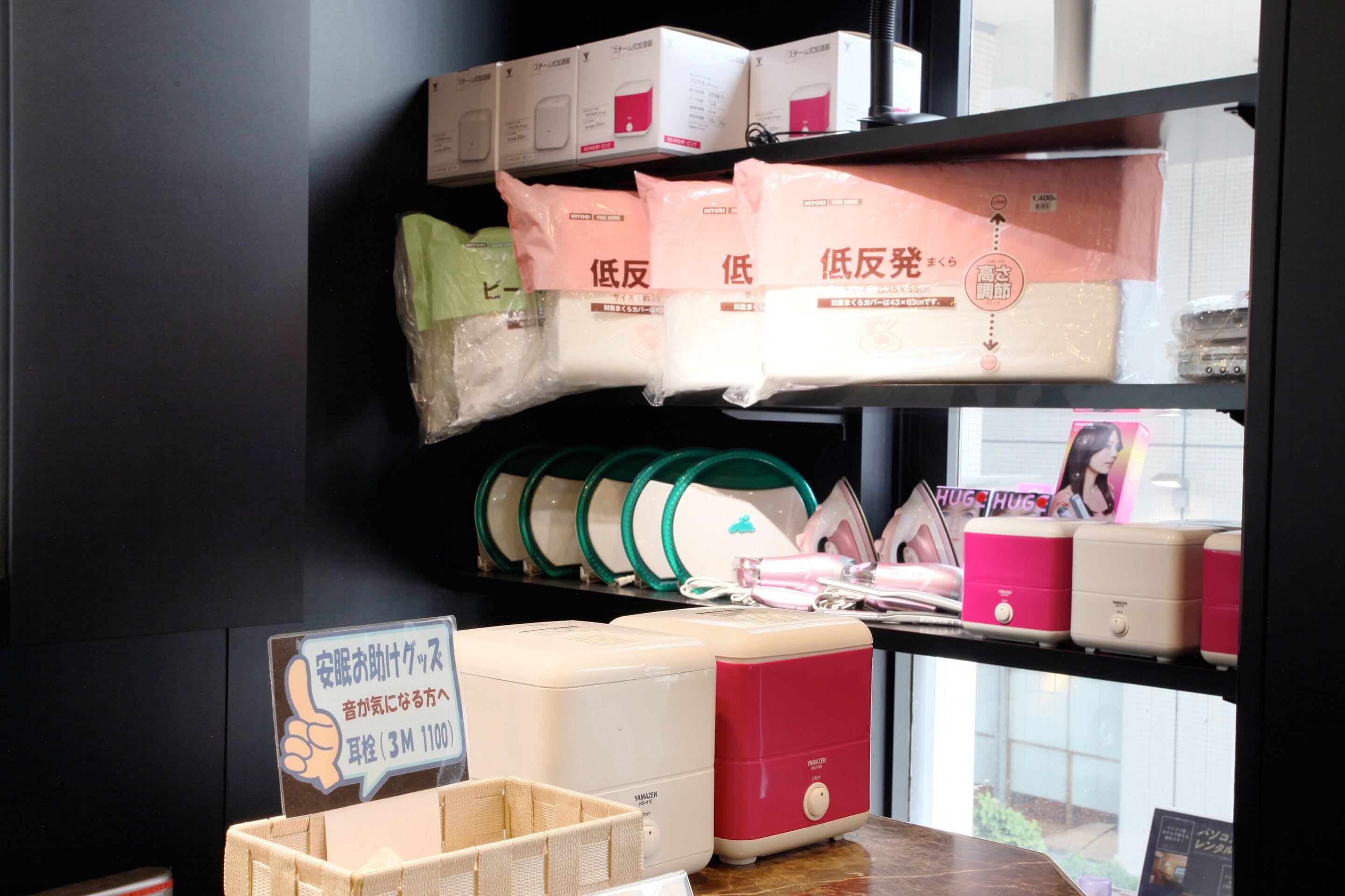 A shelf with various items including bags, a basket, and a sign.