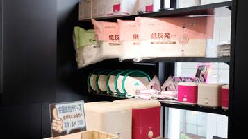 A shelf with various items including bags, a basket, and a sign.
