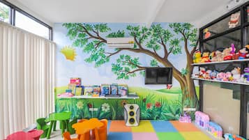 Imaginative play area with a vibrant mural, toys, and educational materials.