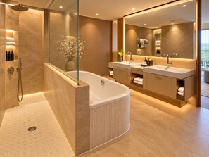 A modern bathroom with a freestanding bathtub, a glass-enclosed shower, and a vanity with dual sinks. - Grand Hotel Palace Schönbrunn (Vienna)