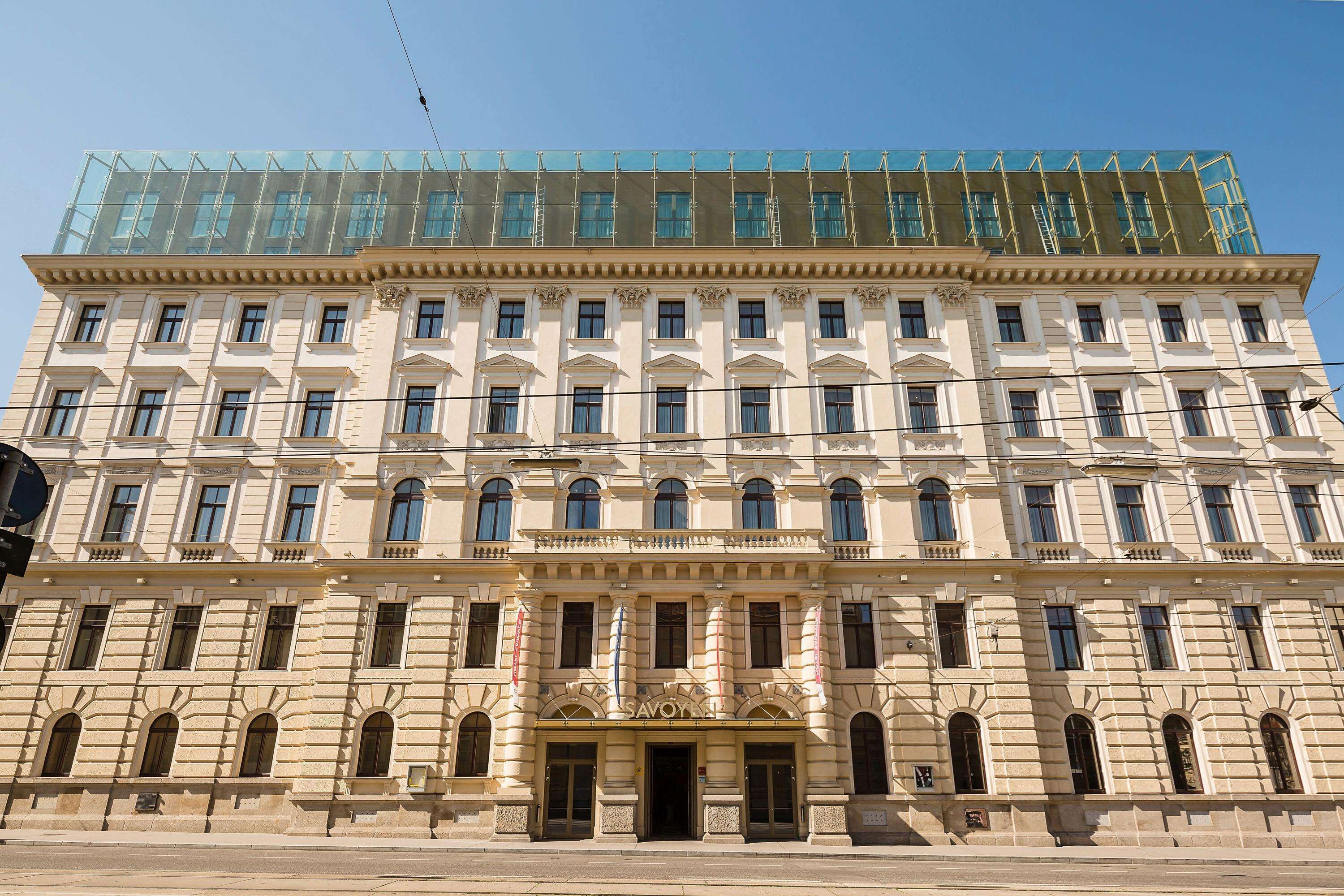 A large, historic building with a classical facade, multiple windows, and a prominent entrance.