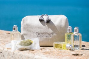 A toiletry bag with toiletries on a stone surface. - Charme Hotel Henry's House (Syracuse)