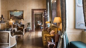 A traditional room with a wooden floor, classic furniture, and a painting on the wall. - Residenza Napoleone III (Rome)