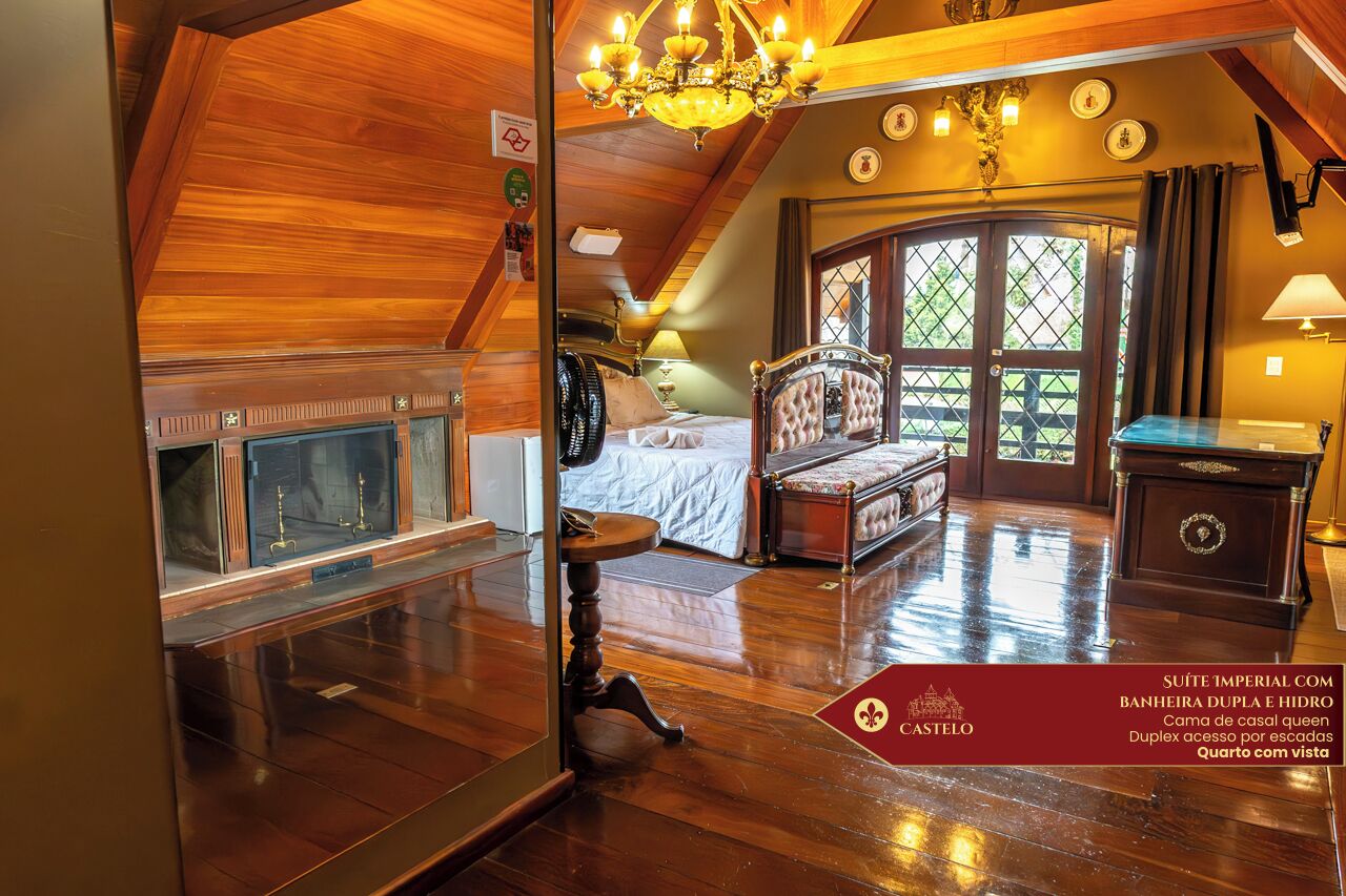 A room with a wooden ceiling, a bed with a canopy, a chandelier, and a view through a window.