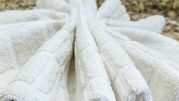 A white towel with a textured pattern, laid out on a surface.