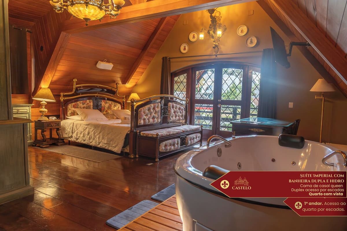 A bedroom with two beds, a large bathtub, and a view of the outside through a window.