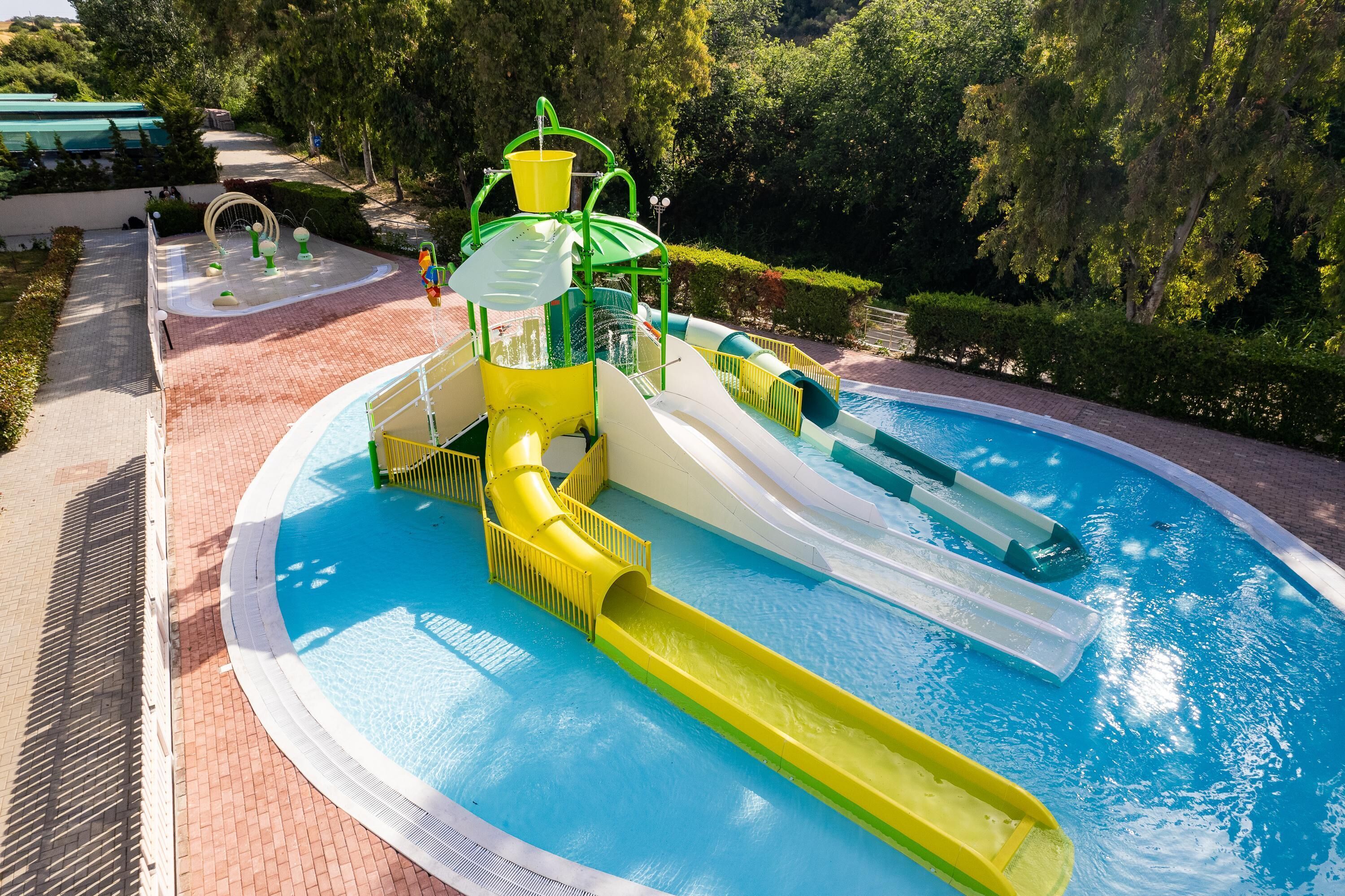 A water park with multiple slides and a pool.