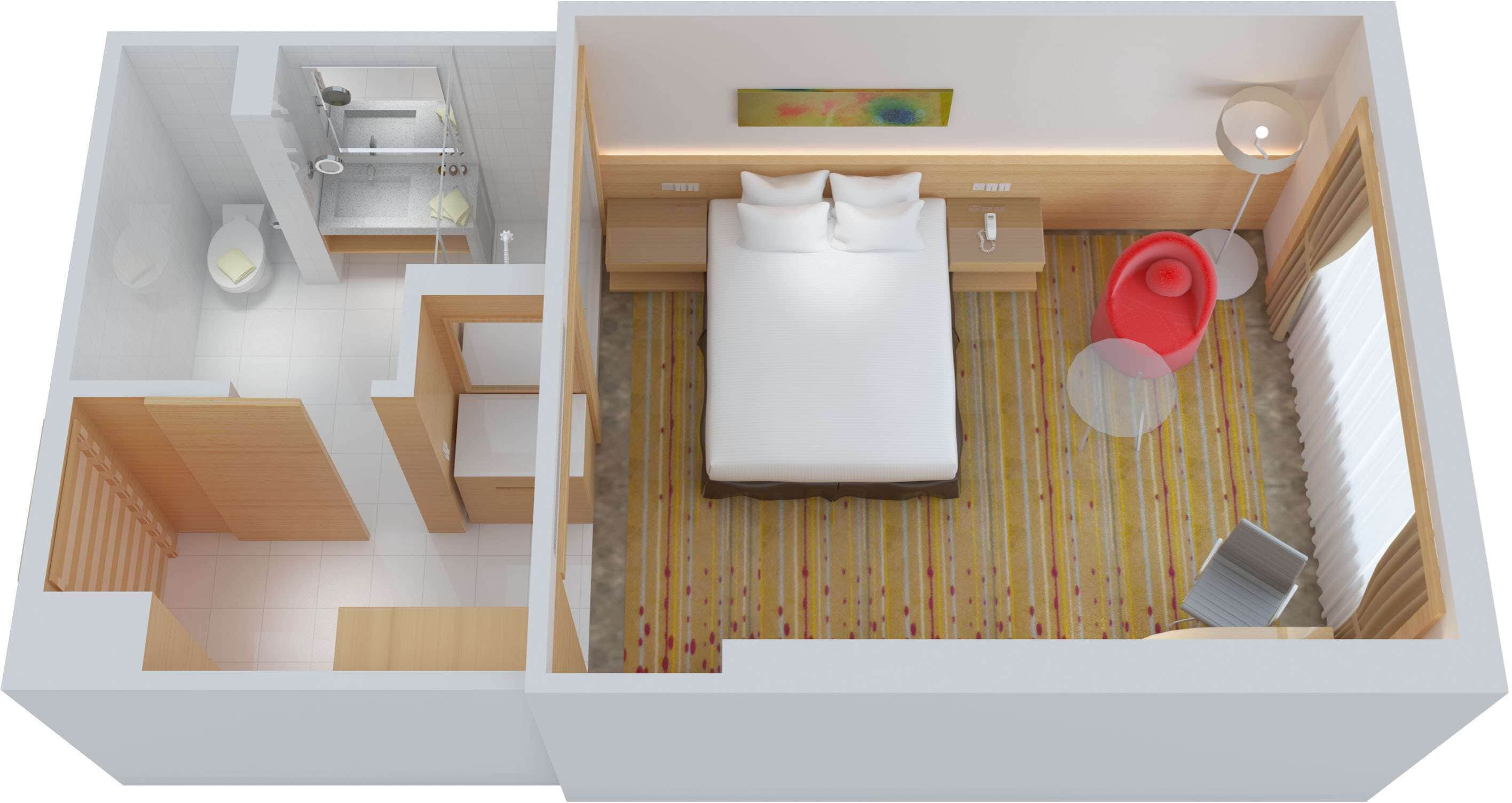 Une chambre d’hôtel moderne comprenant un lit, une petite salle de bain et un coin salon.
